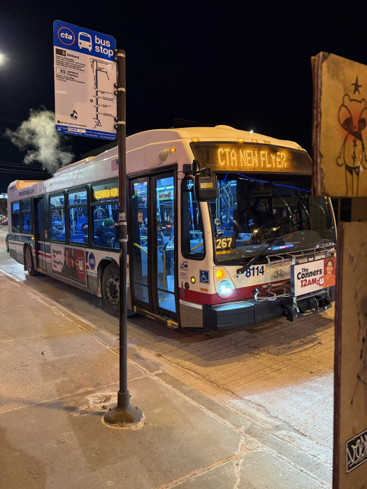 7900 series Nova Bus with front destination sign reading "CTA New Flyer" at a 9 X9 bus stop. Side destination display reads "Cleaner Air"